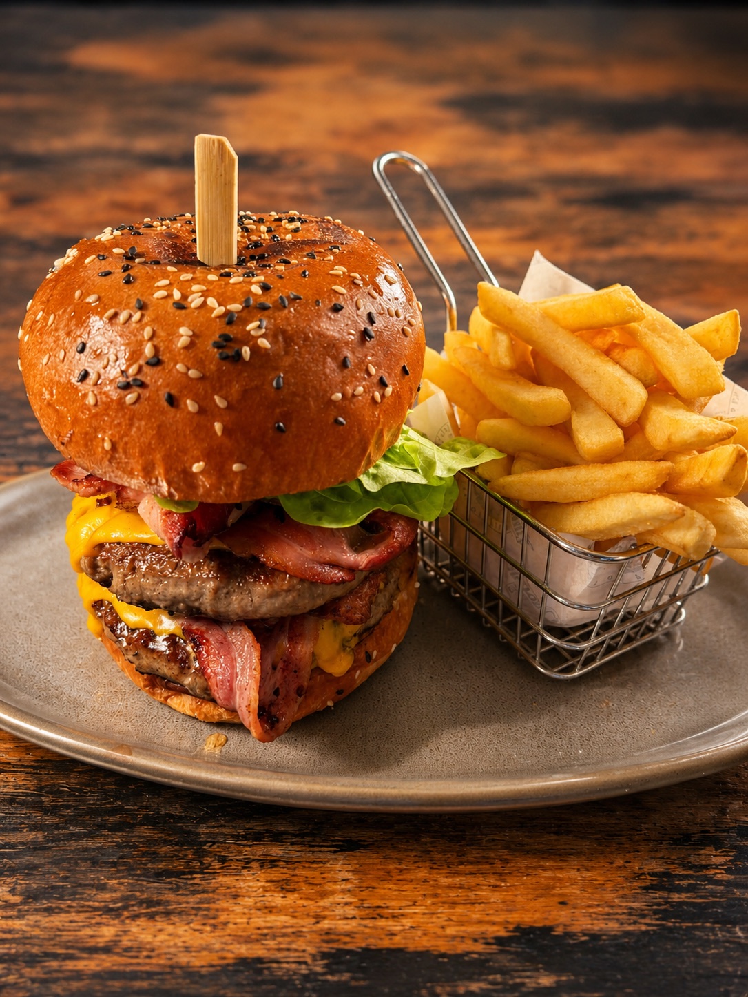 A char-grilled burger on a sesame brioche bun with golden chips at the Rivermill Caf&eacute;